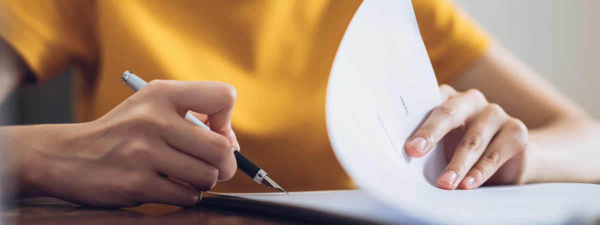 Woman signing document and hand holding pen putting signature at paper, order to authorize their rights.