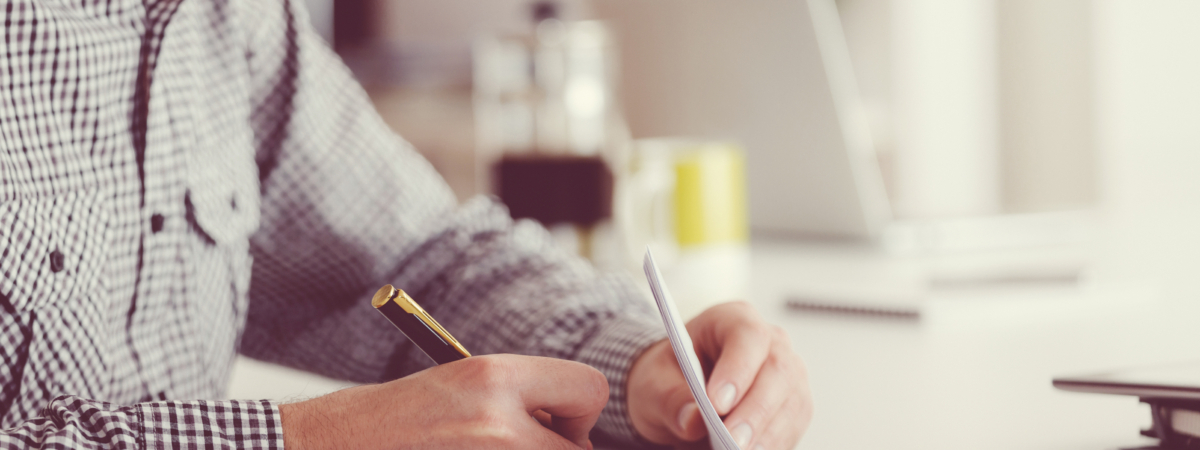 Man signing documents, unrecognizable person