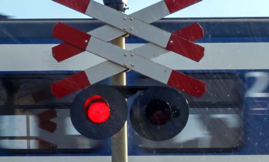 Train called Sprinter passes rail crossing in the Netherlands – Spoorwegovergang – Trein