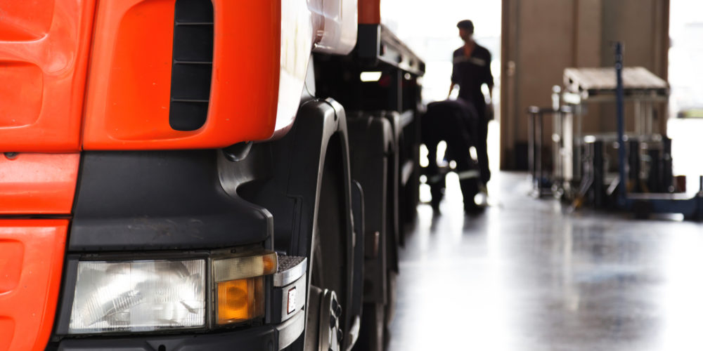 automobile mechanic checking truck in the garage, selective focus