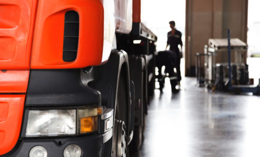 automobile mechanic checking truck in the garage, selective focus