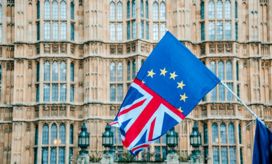 UK and EU flags merged by Houses of Parliament