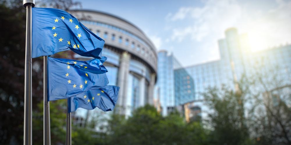 European union flag against parliament in Brussels