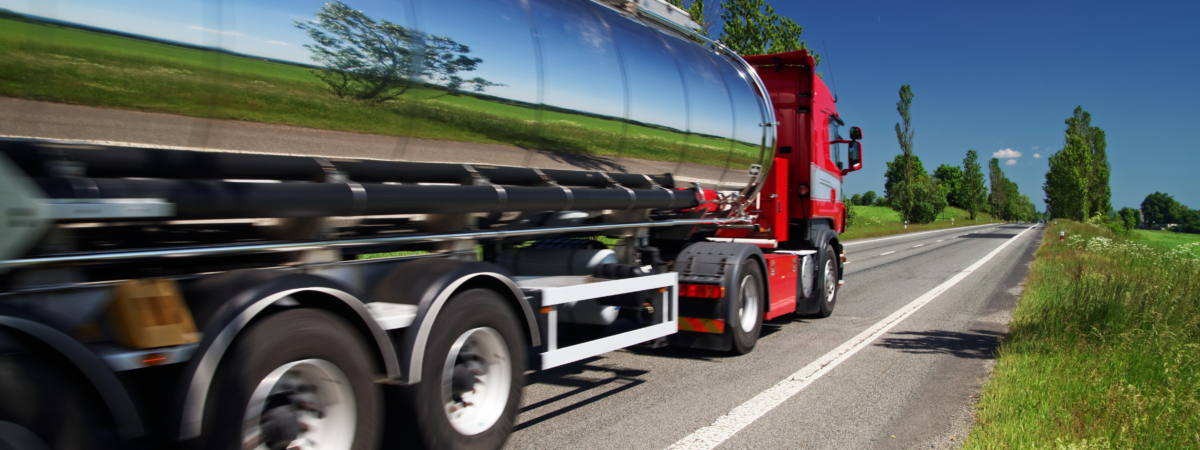 Mirroring the landscape chrome tank truck moving on a highway