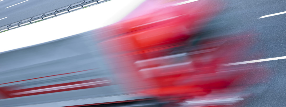 Truck speeding on highway, blurred motion, high angle view