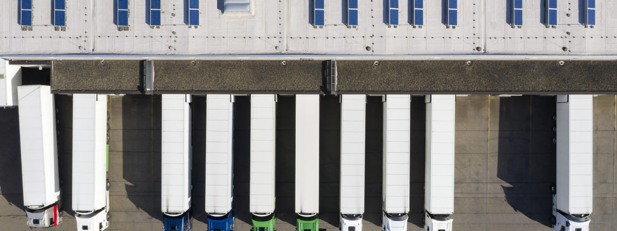 Aerial view of Semi-Trucks Loading at Logistic Center, Distribution Warehouse