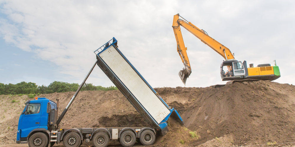 Truck and excavator together build a sound barrier